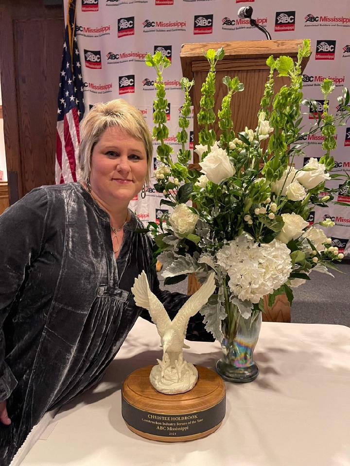 Christee Holbrook poses with trophy and flowers