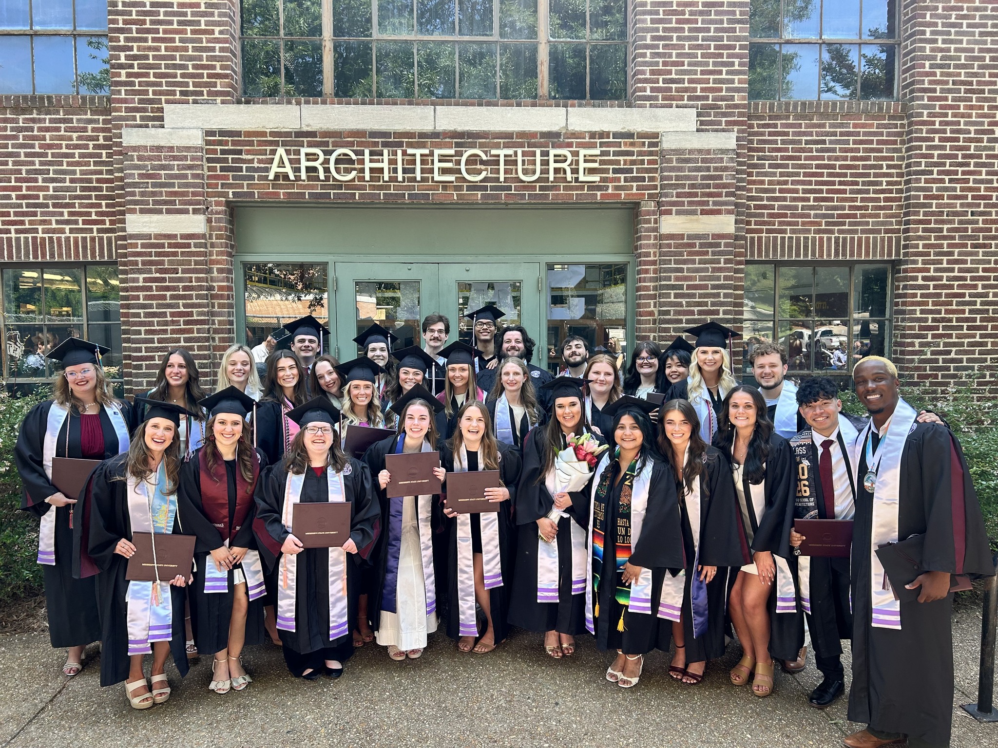 Group photo of Class of 2026 Architecture graduates in front of Giles.