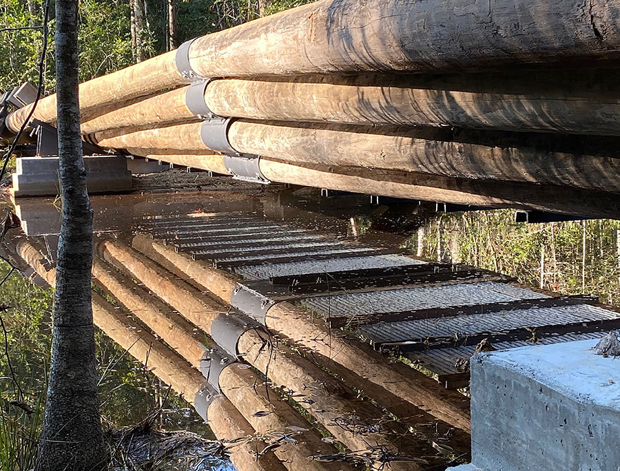 wooden log bridge reflecting on water