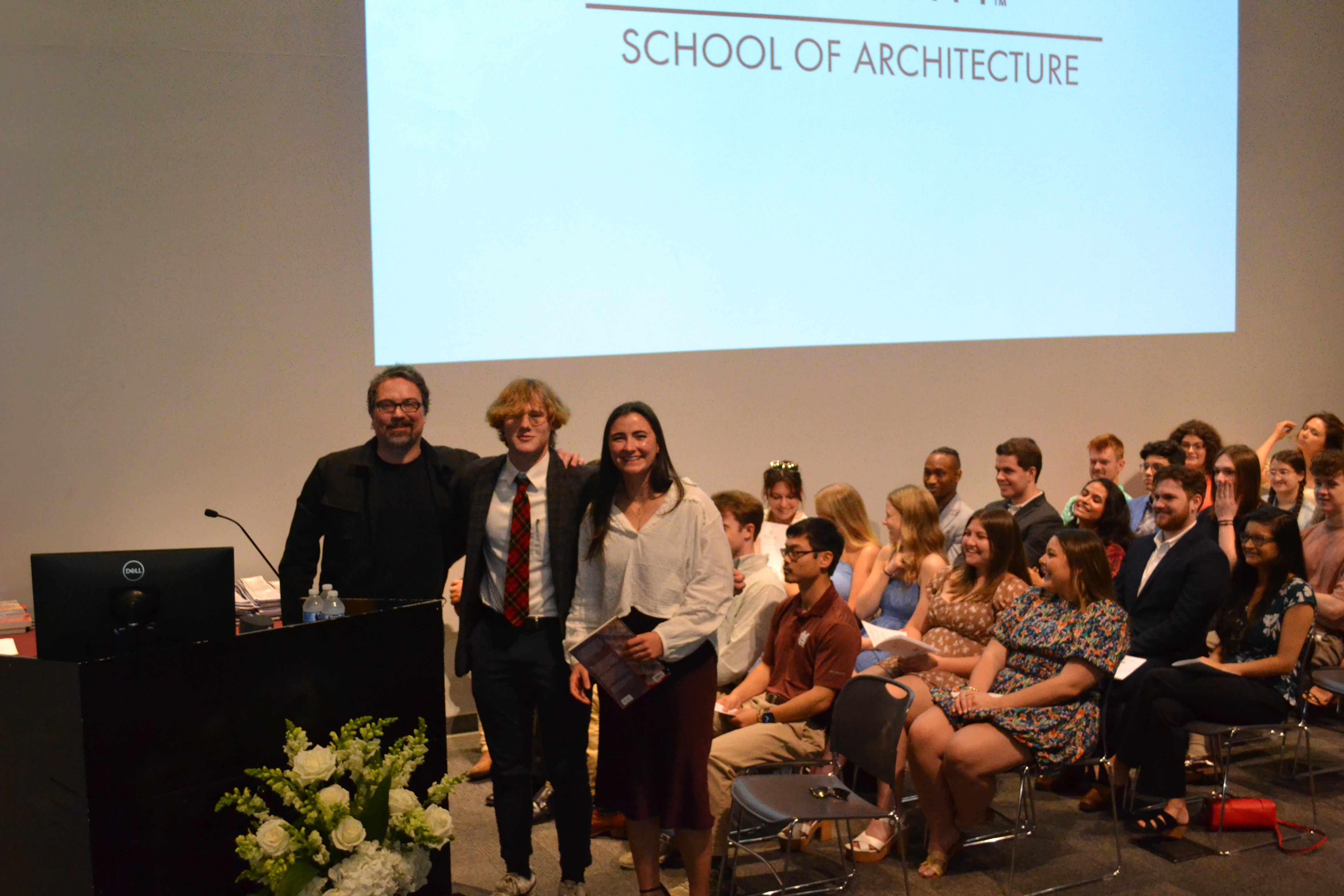 Assistant Professor John Ross stands with second-year book award recipients