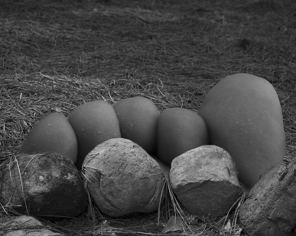 black and white photo by MSU photo student Kaneesha Handy of toes with rocks