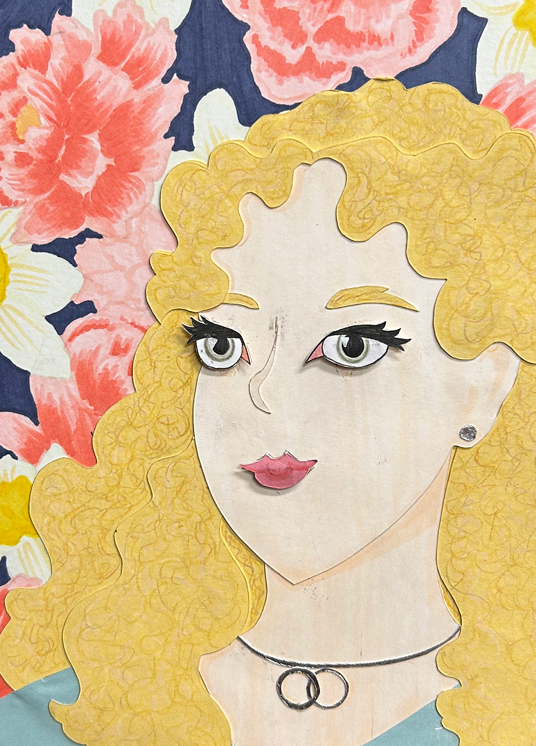 Close-up image of cut-paper portrait of a blonde girl with green eyes. She wears a turquoise shirt and silver jewelry and is place on a dark blue background filled with drawn daffodils and peonies.
