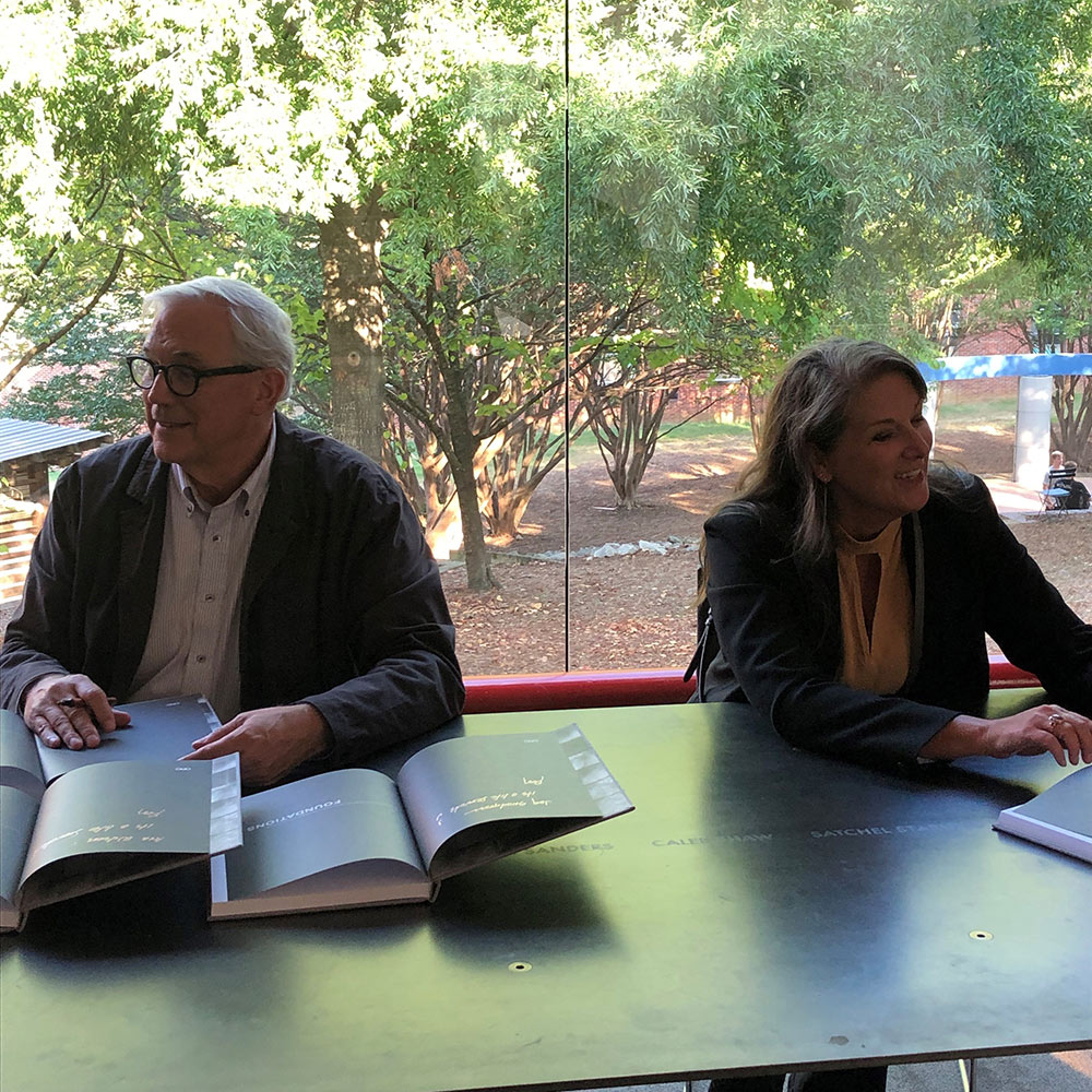 Roy Decker, left, sits with Anne Marie Duvall Decker in front of a window overlooking the back courtyard in Giles as they sign copies of their newest book