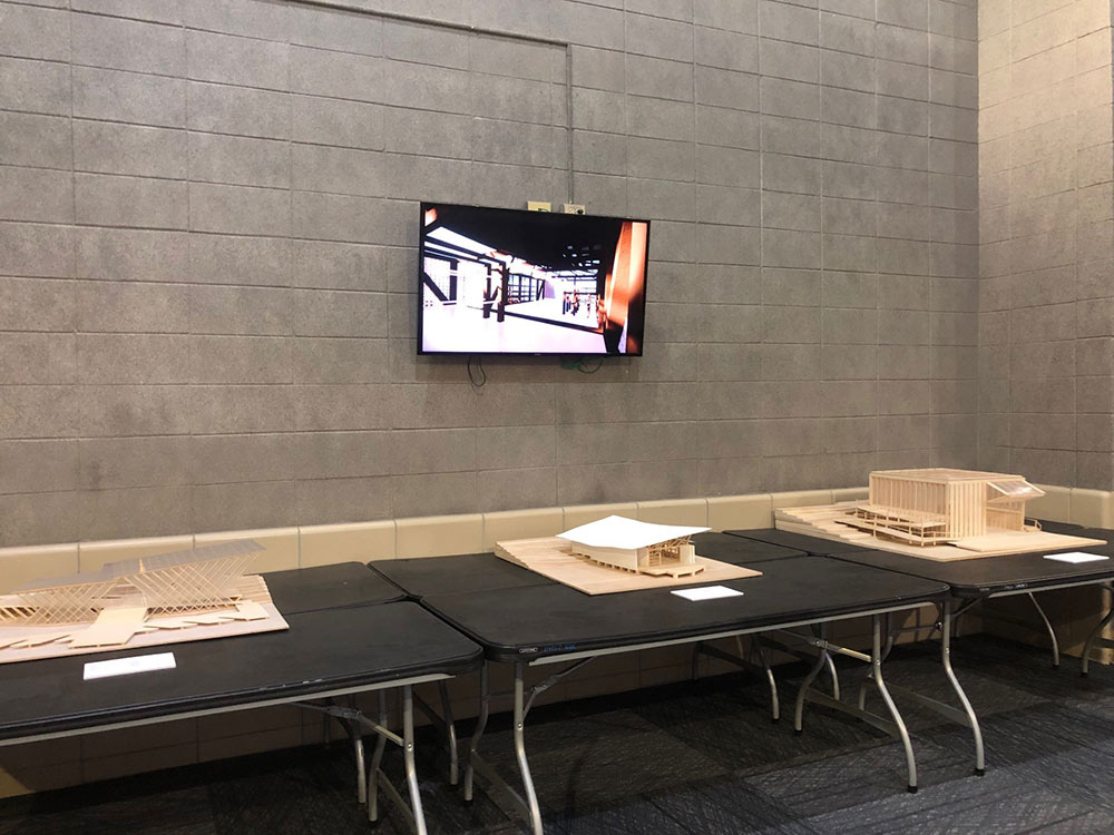 MSU Collaborative Studio boathouse project on display on screen with three models below